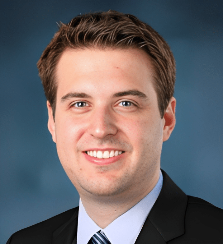 Portrait of Dr. Brent Martin, MD, FAAD, smiling in a dark suit and tie
