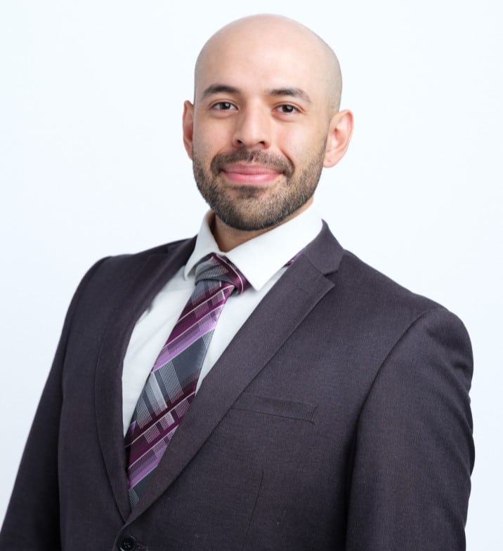 Portrait of David Sanchez, PA-C, smiling in a dark suit and tie